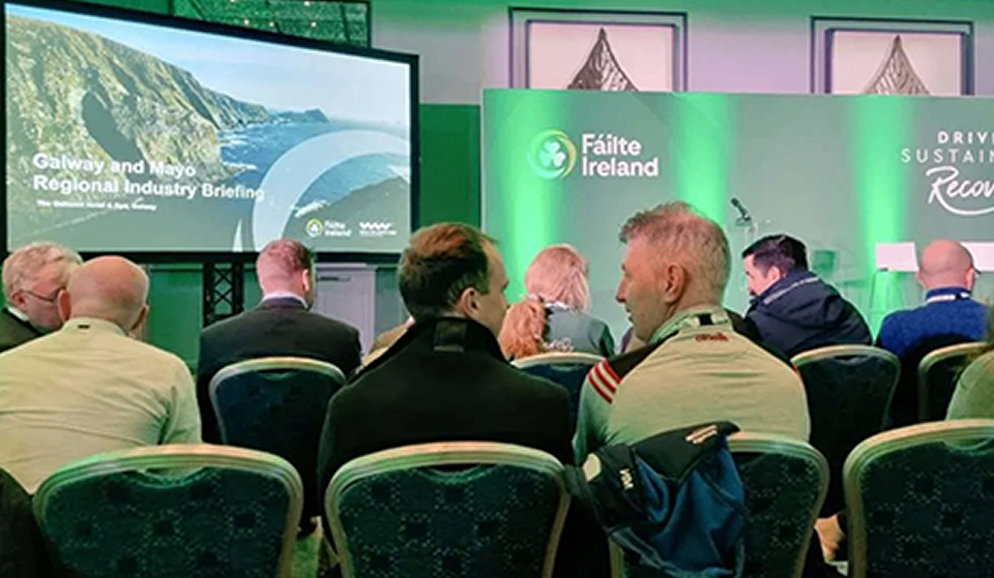 Audience at Galway and Mayo industry briefing event with Fáilte Ireland branding and presentation screen.